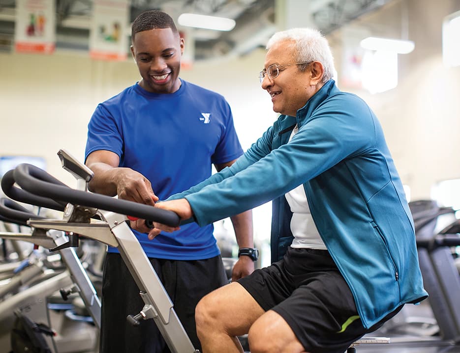 Y Staff training senior on bike