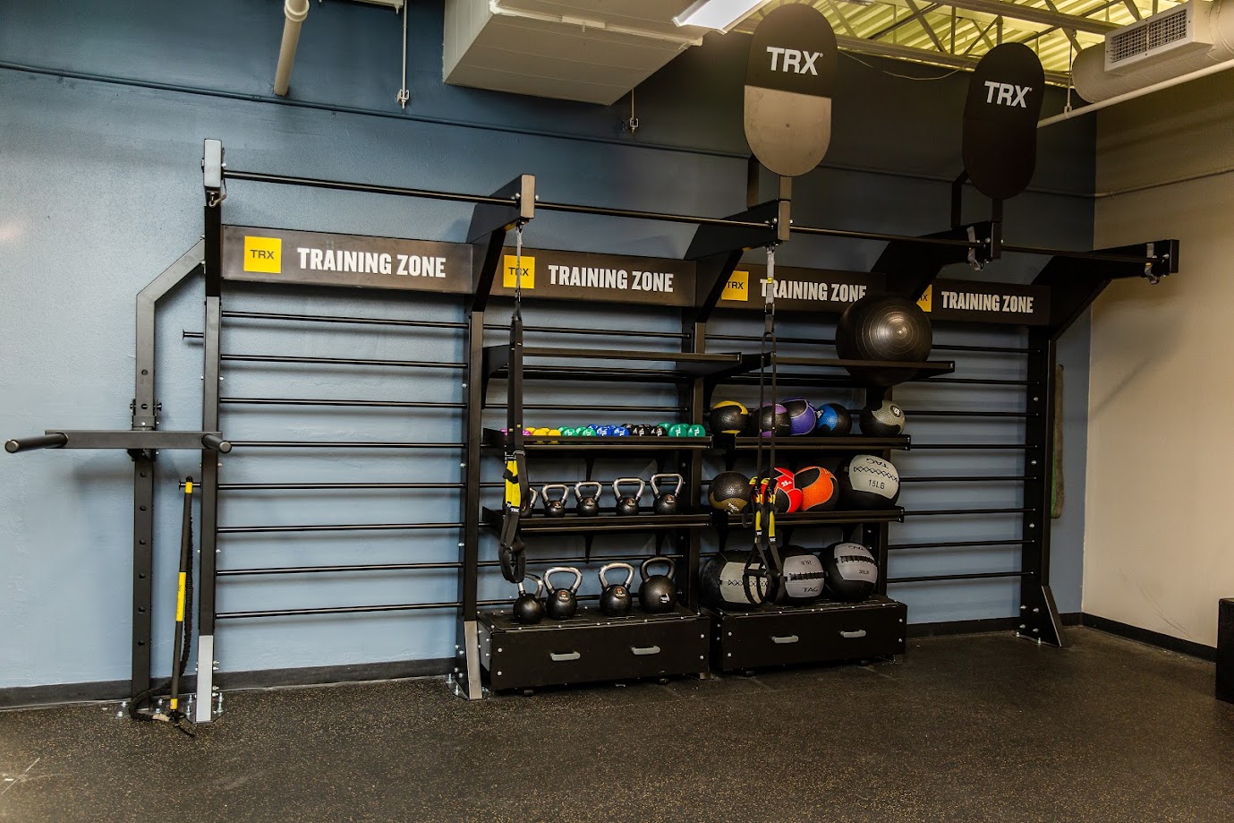 Southwest_TRX Training Zone wall with various weights and medicine balls